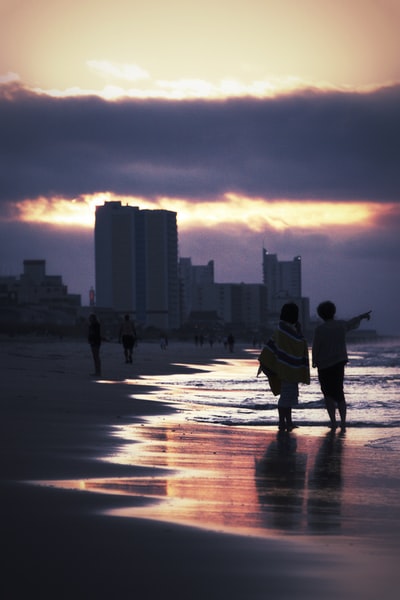 Prime time, two people walking in the buildings near the seaside
